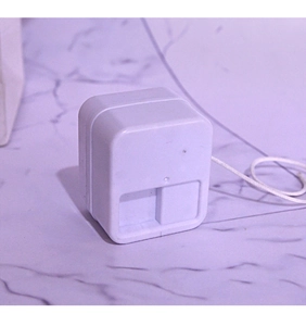 Close-up of DIY music box pull-string mechanical movement toy with white plastic casing