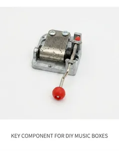 Mechanical 18-note hand-crank music box movement with a red ball handle and silver finish