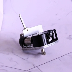 Mechanical wind-up music box movement with black base and silver metal components