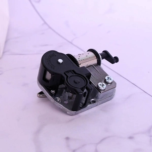 Detailed macro view of Yunsheng mechanical music box movement with gears and crank