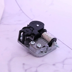 Macro detail of mechanical music box movement with steel comb and brass cylinder