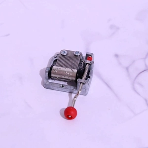 DIY 18-note mechanical music box movement with vintage hand crank and red handle ball