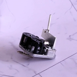 Mechanical wind-up music box movement with silver metal base and black gear housing