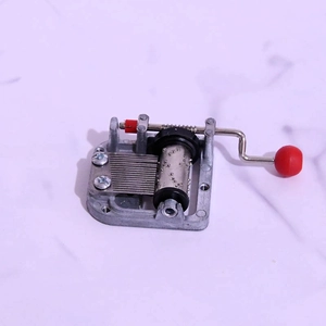 Mechanical 18-note DIY hand-cranked music box movement with silver metal and red handle