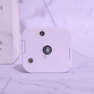 DIY music box movement with white plastic shell and center shaft mechanism on marble