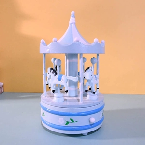 Blue and white carousel music box with hand-painted horses and floral base design