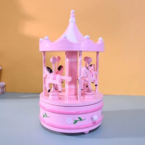 Pink and white carousel music box featuring hand-painted floral patterns on the base