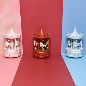Detailed comparison of pink, red, and blue carousel music boxes with ornate canopy designs