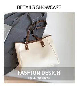 Detail of cream tote bag stitching with golden metal rings and brown leather trim