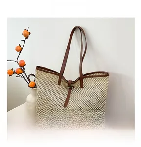 Detail showing the intricate mesh weave texture and brown leather strap of the tote bag