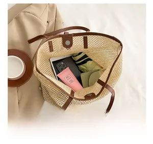 Capacity display of straw tote bag with brown leather handles and magnetic closure