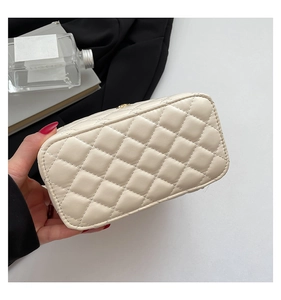 Detail showing the quilted beige leather texture and fine stitching on this box bag