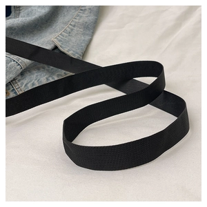 Detail of the durable black woven nylon shoulder strap with a sturdy textured grid pattern
