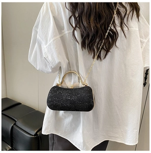 Détail du sac de soirée élégant à paillettes noires avec poignée en métal doré et bandoulière