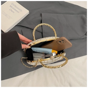 Interior view of white tweed evening bag showing storage for phone and lipstick