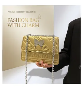 Detail of fashion crossbody bag featuring embossed FASHION text and silver butterfly buckle