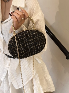 Black tweed chain bag with gold metal handle and elegant diamond clasp for formal events