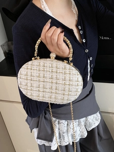 Elegant gold tweed chain clutch bag with diamond-studded ball clasp and metal handle