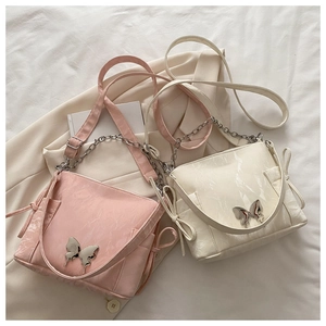 Detail of pink and beige pleated handbags with metal butterfly buckle and chain strap