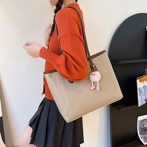 Minimalist apricot large capacity tote bag with brown trim and plush charm detail
