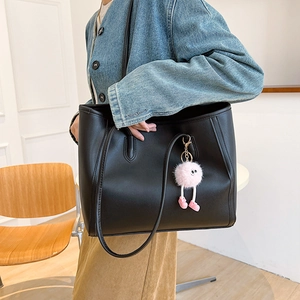 Minimalist black faux leather large tote bag with cute pink plush ball charm accessory