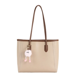 Minimalist large capacity tote bag in cream white with brown straps and pink pompom accessory