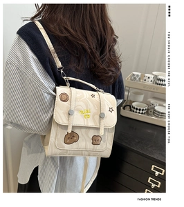Detail showing vintage cream marble texture backpack with cute cartoon embroidery patches