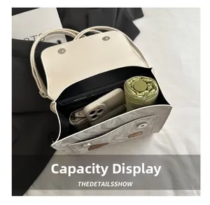 Interior view of marble textured flap bag showing storage for phone, umbrella and wallet