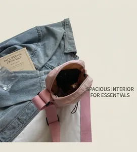 Internal view of a pink nylon crossbody bag showing spacious capacity for a smartphone