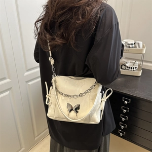 Chic beige shoulder bag with silver butterfly charm and chain detail for women