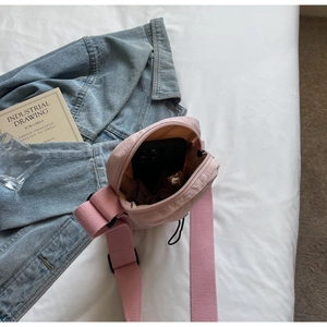 Detail view of the pink crossbody bag interior showing ample space for a smartphone