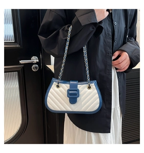 Détail du sac bandoulière matelassé chevron bleu et blanc avec chaîne dorée