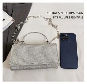 Silver rhinestone evening clutch with round metal handle and delicate chain strap details