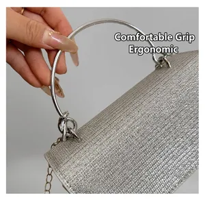 Detail of silver sparkling woven clutch with metallic handle and chain shoulder strap