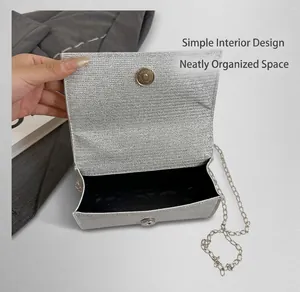 Detailed interior of a silver glitter evening bag with black lining and magnetic closure