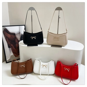 Detailed comparison of five crocodile-pattern underarm bags with golden bow buckles