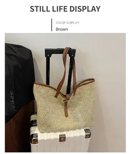 Detail of woven tote bag with brown leather straps displayed on a white suitcase