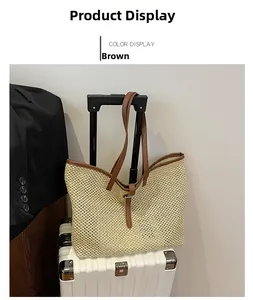 Detail of woven tote bag with brown leather straps displayed on a white suitcase