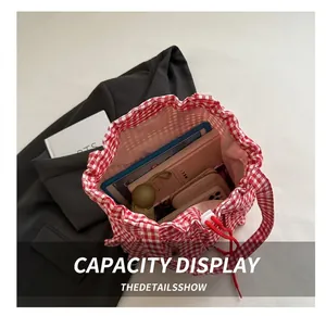 Internal view of red and white gingham tote bag showing large storage capacity