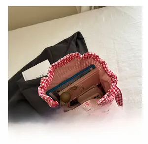 Internal view of red and white gingham tote bag showing large storage capacity