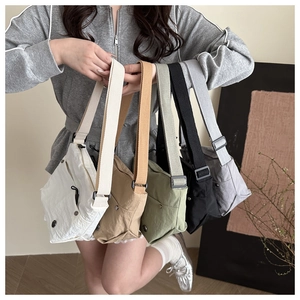 Detailed display of lightweight nylon crossbody bags in five colors with wide straps