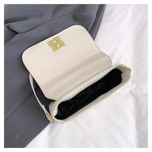 Detail view of the open white PU leather shoulder bag with gold clasp and black lining