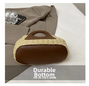 Close-up of the durable wear-resistant leather bottom on the woven straw tote bag