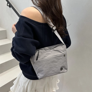 Fashionable light grey nylon crossbody bag for women with adjustable shoulder strap