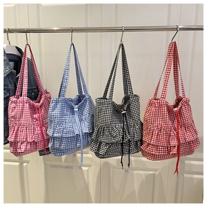 Detail of checkered tote bags with ruffle edges and drawstring in four colors