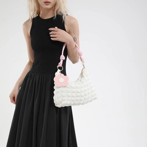 White bubble texture shoulder bag with pink woven rope handle and flower charm details