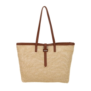 Straw woven tote bag with brown leather handles and metal buckle for summer beach vacation