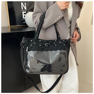 Detail of black ita bag featuring heart studs and a clear window for custom decoration