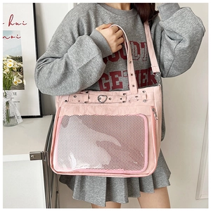 Pink canvas tote bag with front mesh pocket and heart-shaped metal detail for women