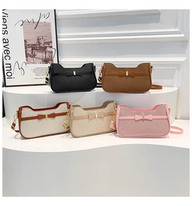 Close-up of textured shoulder bags in multiple colors featuring elegant front bow details